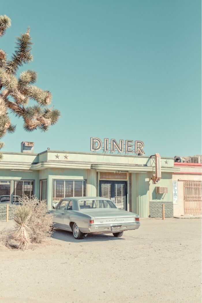 A retro diner and vintage car in the American West, capturing the rusty and dusty remnants of a bygone era.