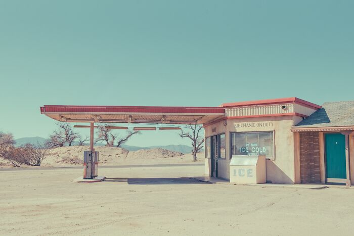 A dusty, abandoned gas station in the American West, capturing the rusty remnants of a bygone era.