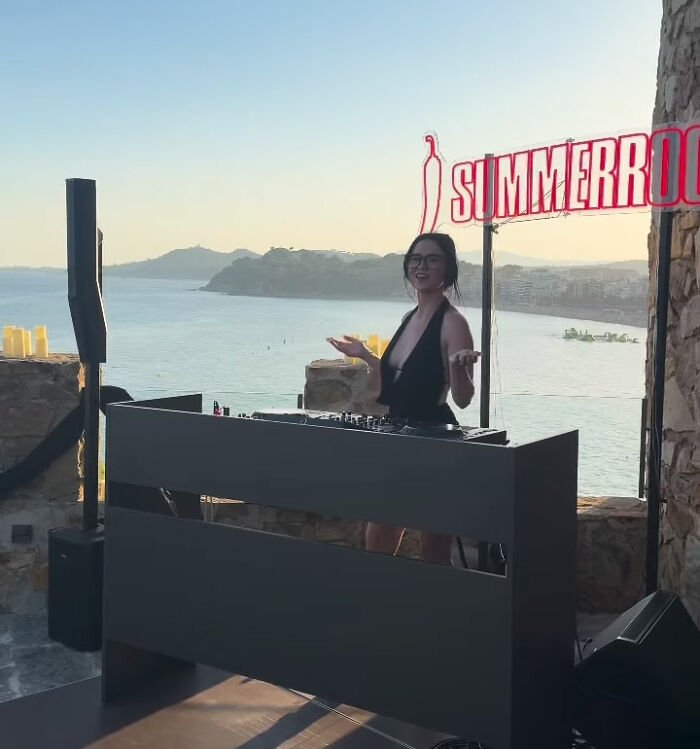 A girl in a black outfit DJs by the ocean, generating new content for an adult platform. A girl in a black outfit DJs by the ocean, generating new content for an adult platform.