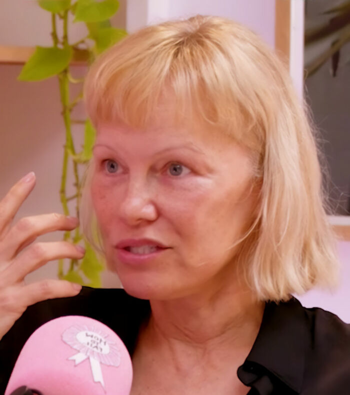 Pamela Anderson with blonde hair and a microphone, revealing details of her harrowing health battle. Pamela Anderson with blonde hair and a microphone, revealing details of her harrowing health battle.