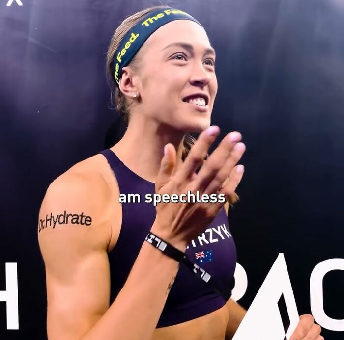 Athlete with a headband and sport top, looking surprised and emotional, after her HYROX race.