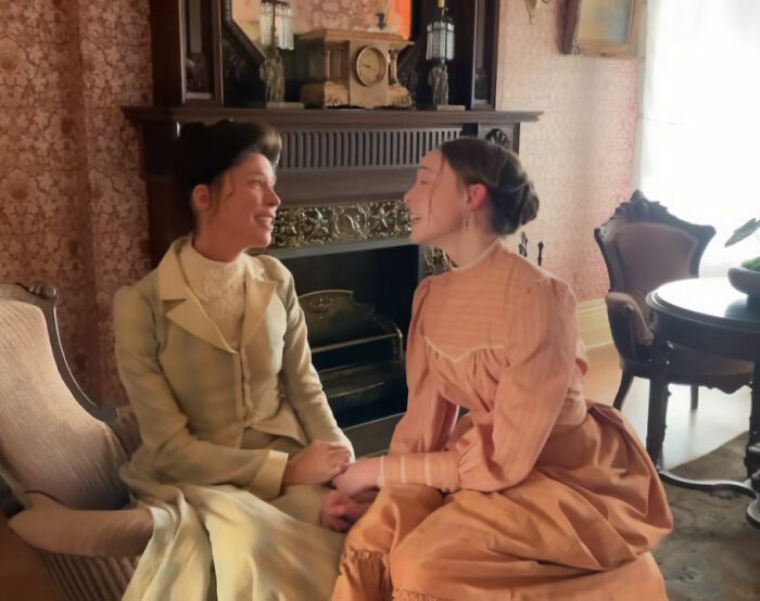 Two women in period dresses sitting together from Lizzie Borden series Two women in period dresses sitting together from Lizzie Borden series