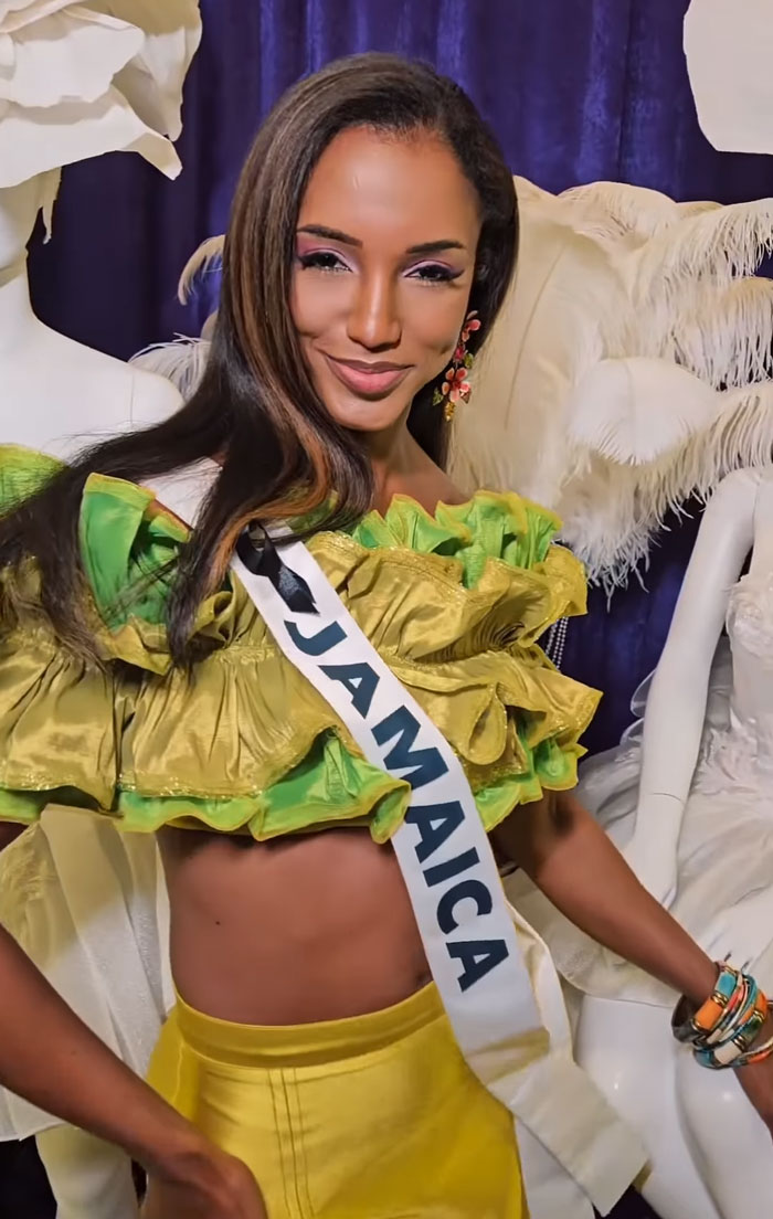 Miss Universe Jamaica Gabrielle Henry wearing a green ruffled top and sash smiling for the camera Miss Universe Jamaica Gabrielle Henry wearing a green ruffled top and sash smiling for the camera