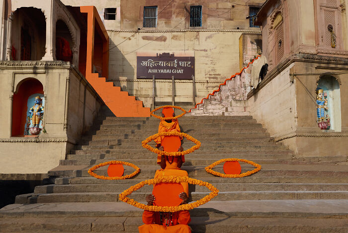 Surreal art expedition photo art installation at Ahilyabai Ghat with orange eye shapes on stairs