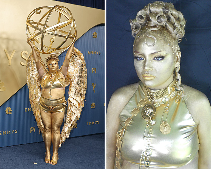 A star in a worst dressed outfit at the 2026 Emmys, covered in gold body paint, holding a large golden sphere, with golden wings.