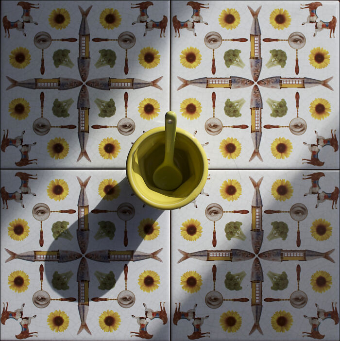Patterned tile works with sunflowers, fish, and kitchen utensils with yellow cup