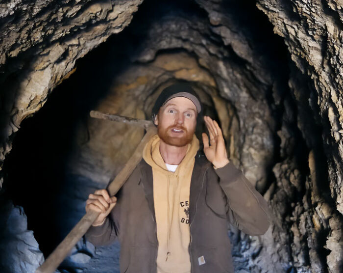 Brent Underwood holding a pickaxe inside a dark mine tunnel in his entire ghost town. Brent Underwood holding a pickaxe inside a dark mine tunnel in his entire ghost town.