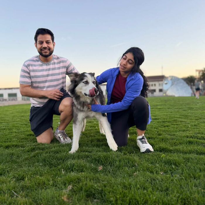 A man and woman kneel with their husky dog, part of a supportive community for pet owners. A man and woman kneel with their husky dog, part of a supportive community for pet owners.