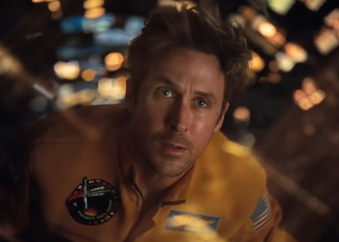 Ryan Gosling looking upward in an astronaut suit, showcasing Hollywood's plastic surgery obsession.