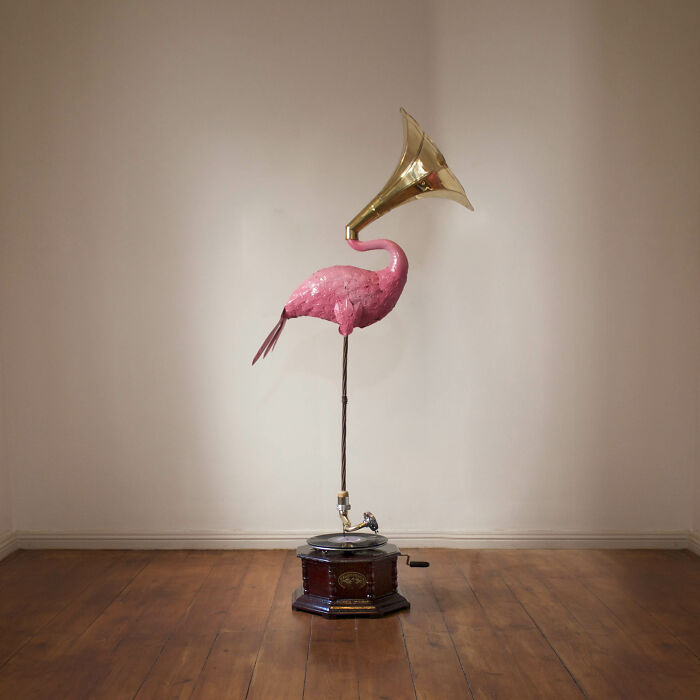 Tile works art with pink flamingo and gramophone sculpture on wooden floor