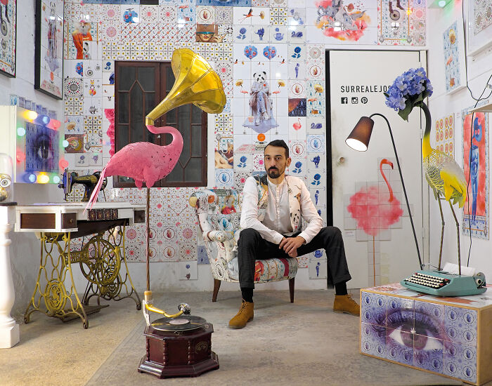 Man sitting in room with colorful tile works art covering walls