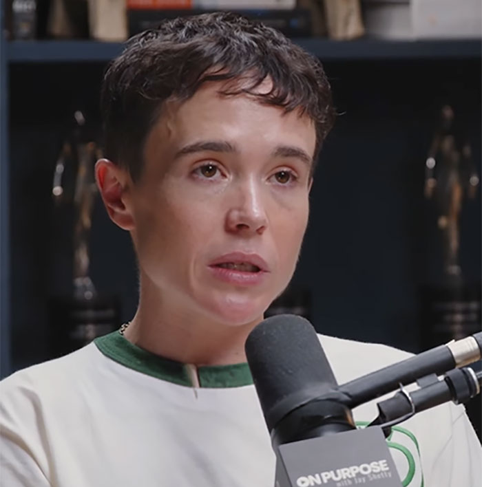 Trans actor Elliot Page speaking into a microphone, discussing Hollywood's bleak reality after 'The Odyssey'. Trans actor Elliot Page speaking into a microphone, discussing Hollywood's bleak reality after 'The Odyssey'.