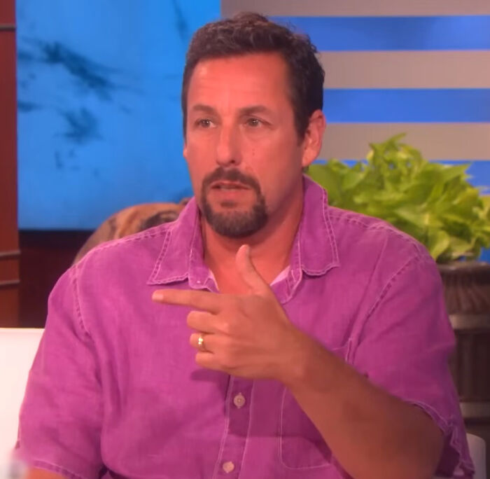 Adam Sandler pointing, sharing his brutal hot takes on celebrities.