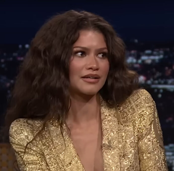 Zendaya looking surprised, reacting to brutal celebrity hot takes.
