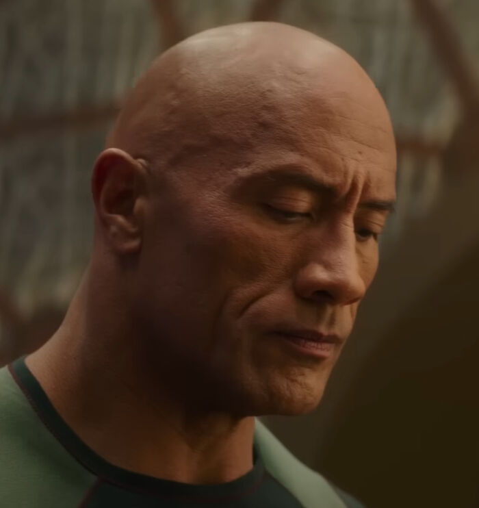 The Rock looking down, reflecting on brutal hot takes about celebrities.