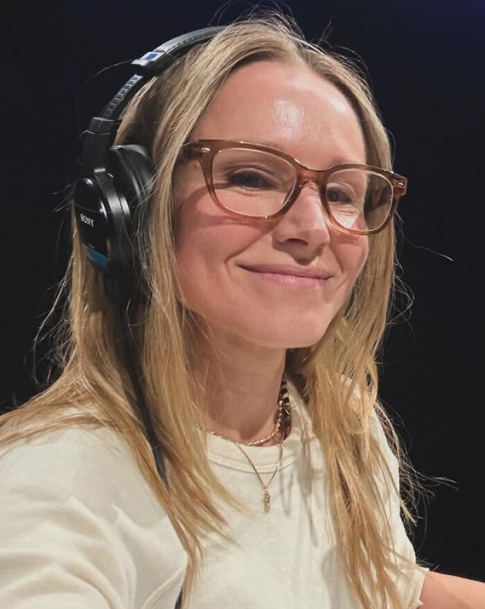 Kristen Bell, a celebrity, smiles wearing headphones and glasses, reflecting on brutal hot takes.