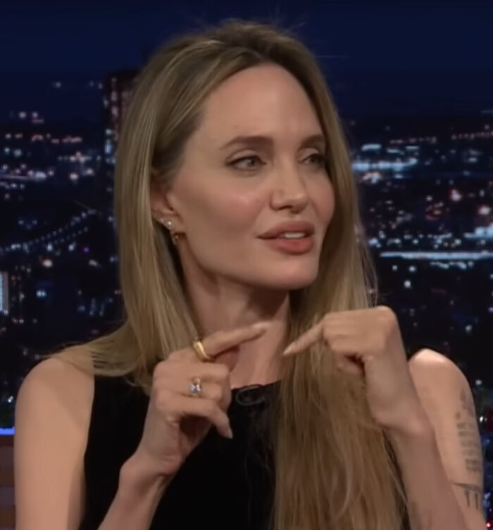 Angelina Jolie, a celebrity, gestures while speaking, illustrating candid brutal hot takes people have.
