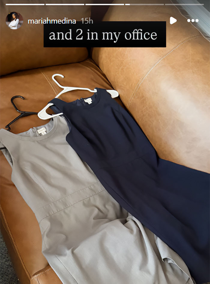 Two professional dresses, one grey and one navy blue, resting on a leather couch.