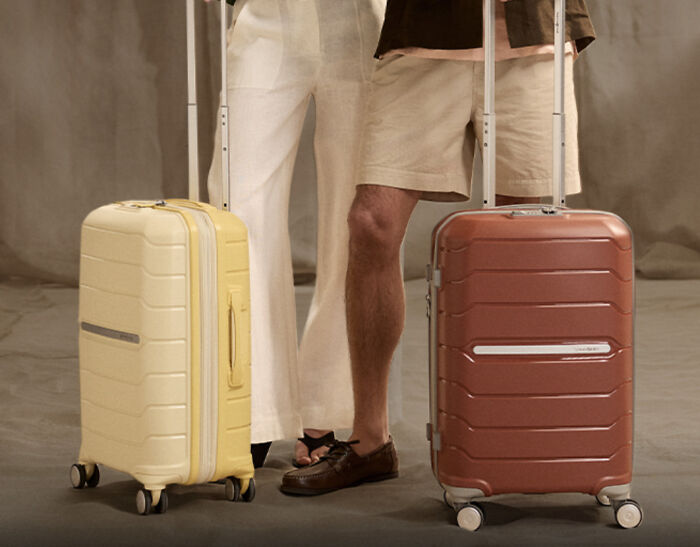 Yellow and brown rolling suitcases held by travelers, selected for Prime Big Deal Days