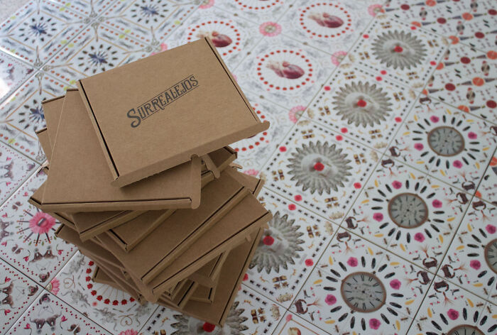 Stack of tile works boxes on patterned decorative tile floor