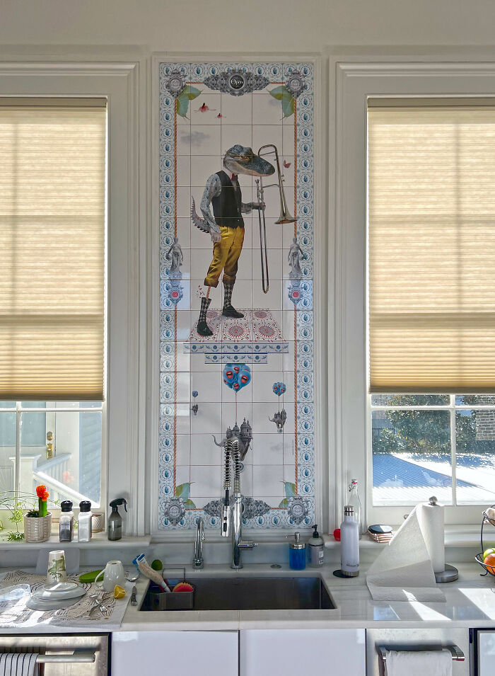 Tile works mural of anthropomorphic alligator playing trombone above kitchen sink