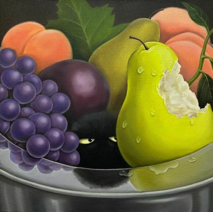 A black cat with glowing eyes peeks from behind a bowl of surreal fruit, including a bitten pear.