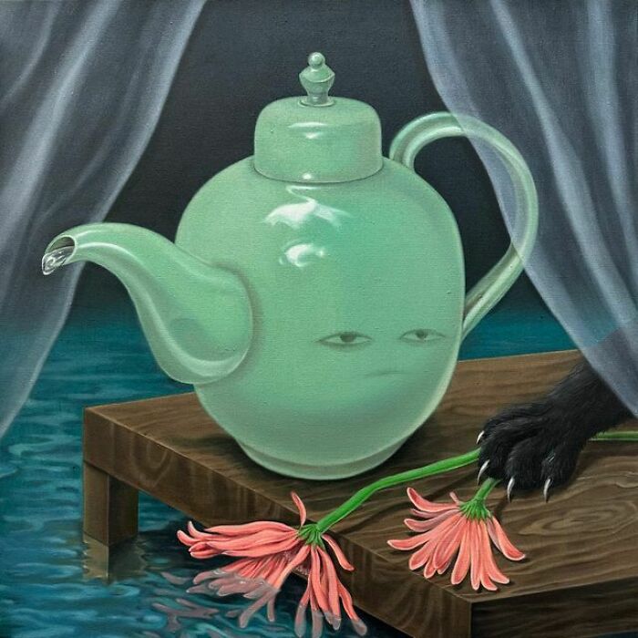 A black cat's paw holds two pink flowers next to a surreal teapot with eyes, floating in water.