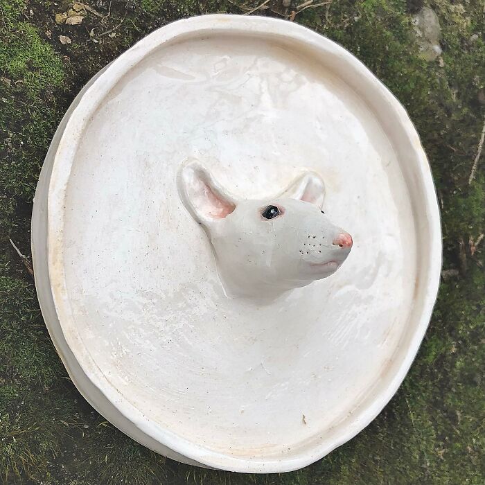 A quirky ceramic dish shaped with a mouse head emerging from the center.