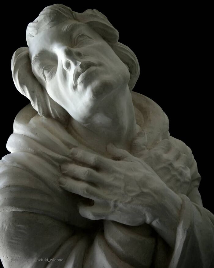 Detailed wood sculpture of a man looking upward by a Polish artist