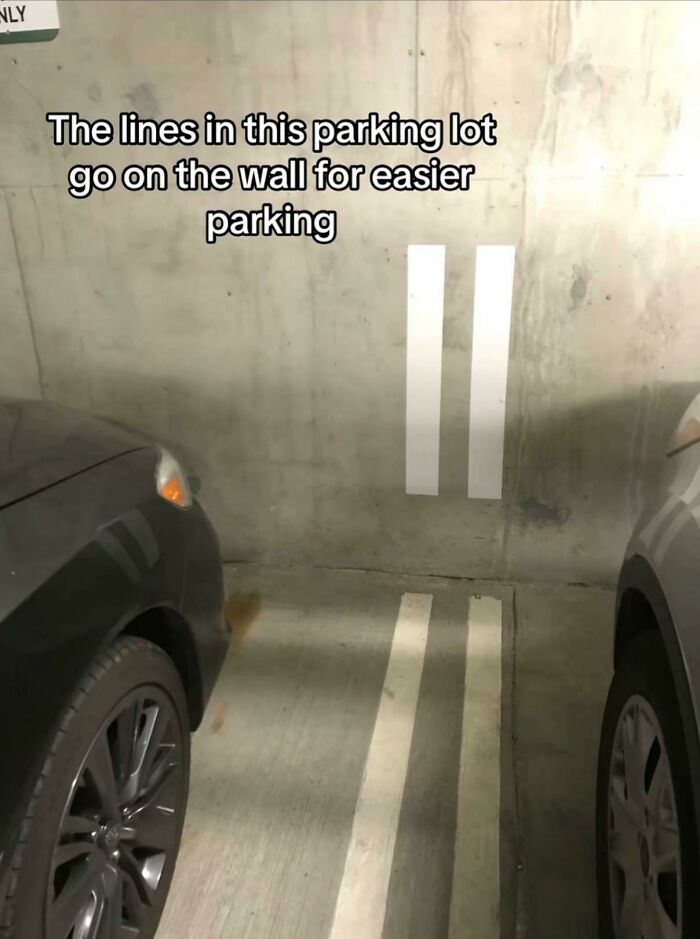 Parking lot with lines extending onto wall for easier parking clever design