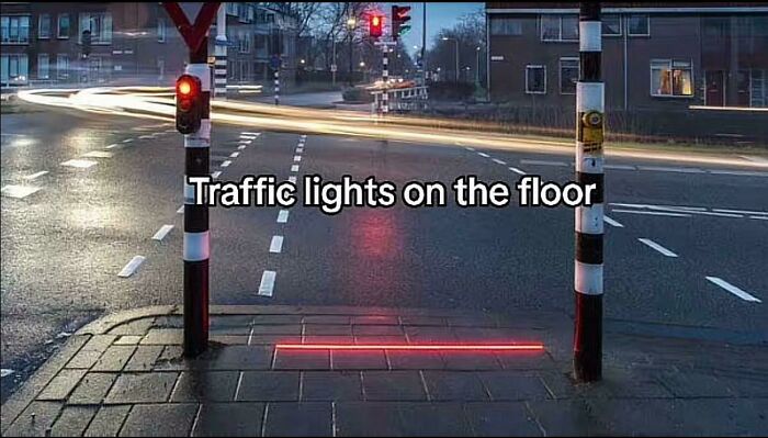 Innovative traffic lights displayed on the floor for pedestrian safety at a crosswalk