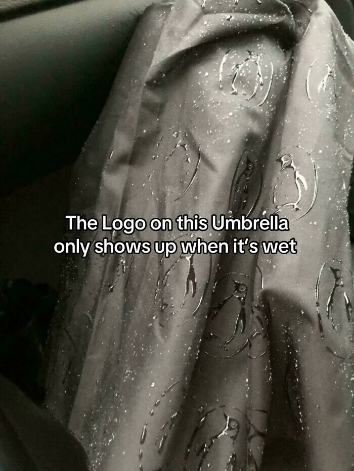 Umbrella logo reveals penguins only when it gets wet