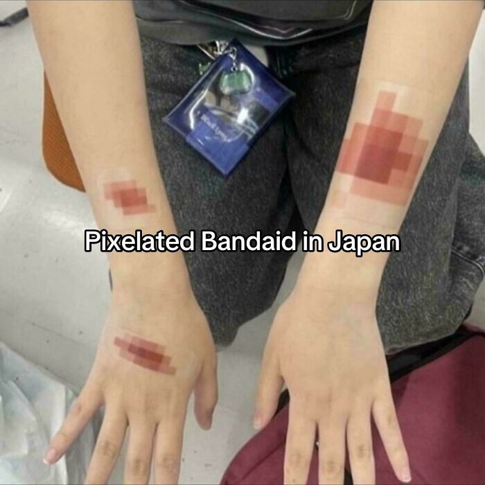 Pixelated adhesive bandages worn on arms in Japan