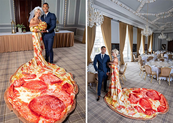 Bride in pizza slice wedding dress and groom posing in elegant dining hall