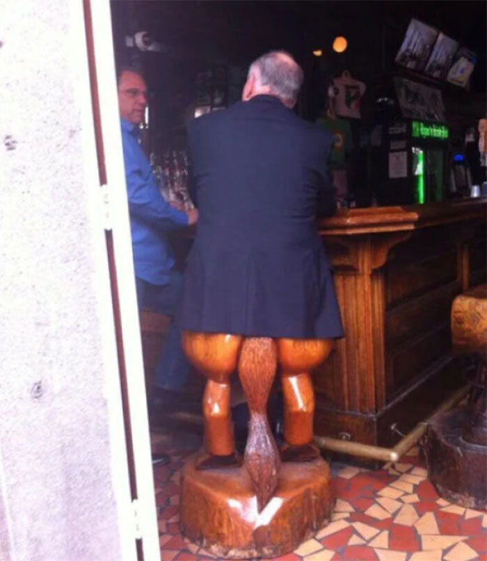 Wooden bar stool with legs and tail design showing craftsmanship wasted on weird concept