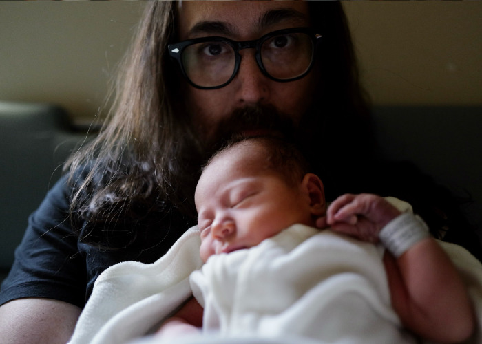 Sean Ono Lennon holding his newborn, John Lennon's first grandson, with an unusual name. Sean Ono Lennon holding his newborn, John Lennon's first grandson, with an unusual name.