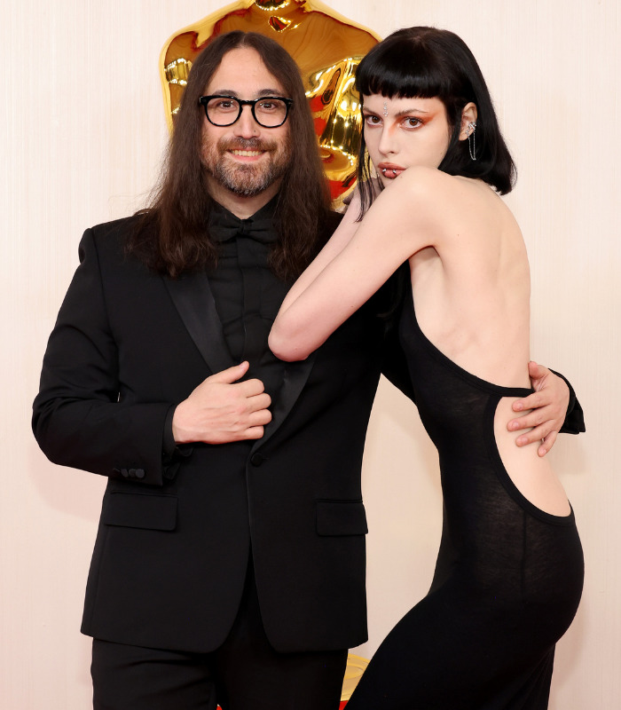 Sean Ono Lennon with his partner, John Lennon's grandson, posing on a red carpet. Sean Ono Lennon with his partner, John Lennon's grandson, posing on a red carpet.
