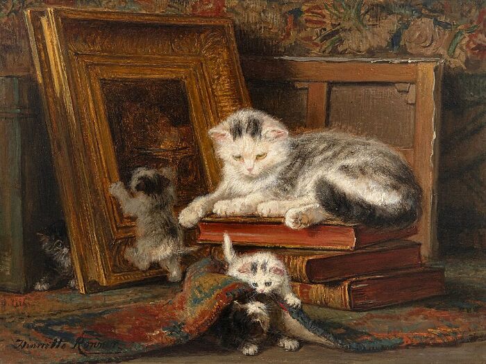 19th century cat painting of kittens playing with an empty picture frame and books.