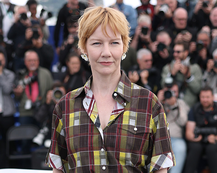 Actress with short blonde hair and plaid shirt, facing scrutiny over a snobbish red carpet response. Actress with short blonde hair and plaid shirt, facing scrutiny over a snobbish red carpet response.