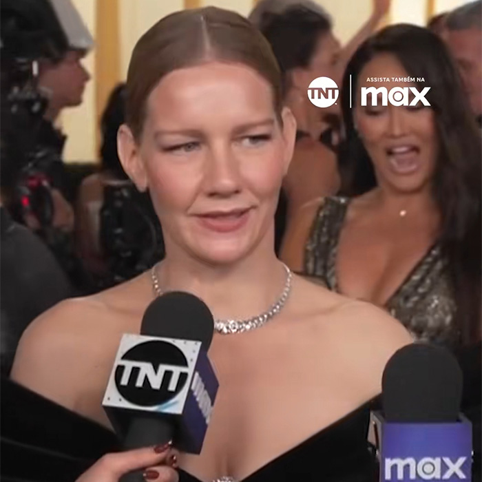 Actress on the red carpet with a mic, in a black off-shoulder dress, facing scrutiny for her snobbish response. Actress on the red carpet with a mic, in a black off-shoulder dress, facing scrutiny for her snobbish response.