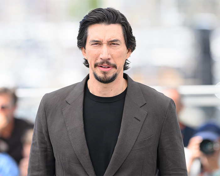 Adam Driver looking at the camera, sparking plastic surgery speculation.
