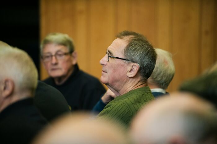 A client in glasses, looking serious, demonstrating lawyers shocked by stupid clients.