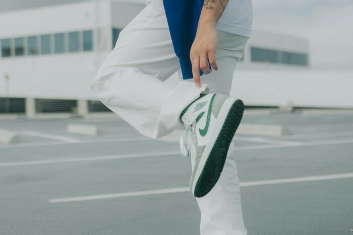 Person displaying green sneakers, dealing with a plane seatmate from hell