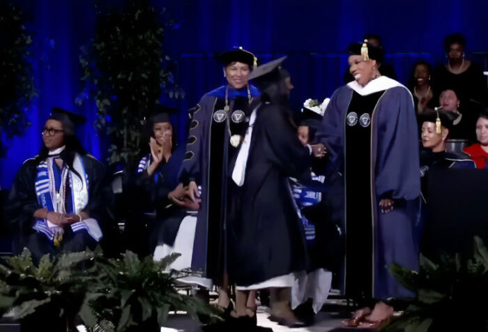 Zahara, Angelina Jolie's daughter, participating in a university graduation ceremony on stage.
