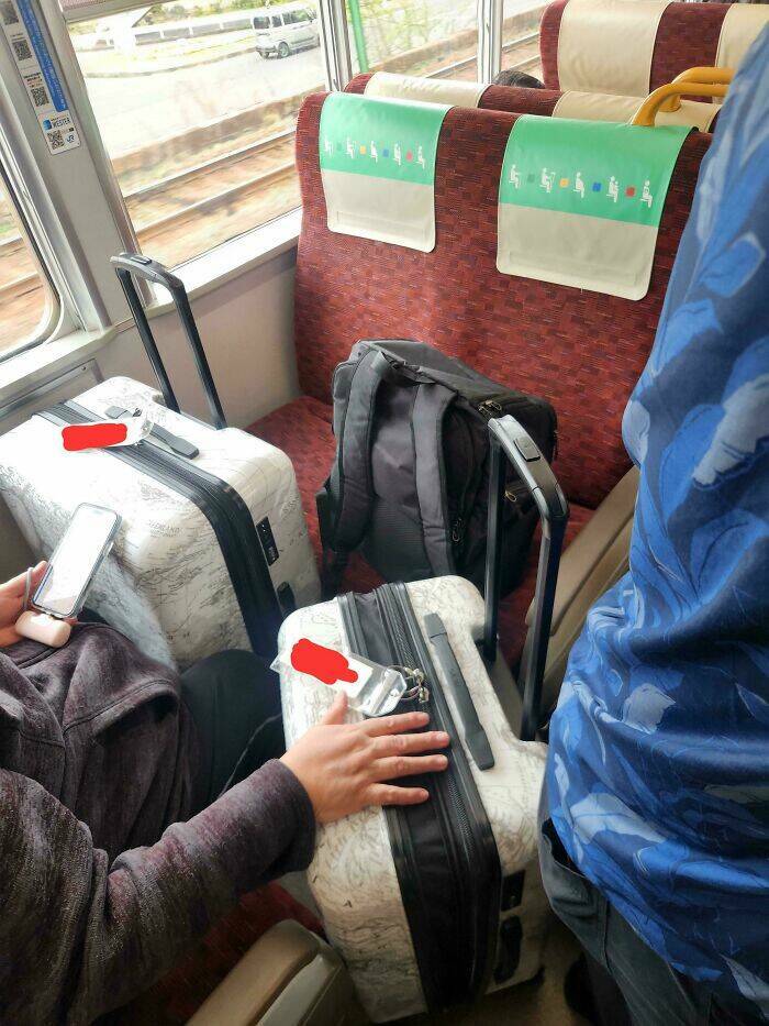 Passengers block multiple seats with luggage, a classic public transport annoyance