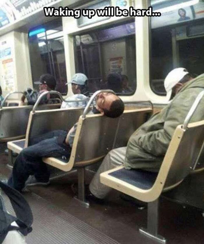 A passenger sleeping on public transport with his head awkwardly stuck through the seat frame
