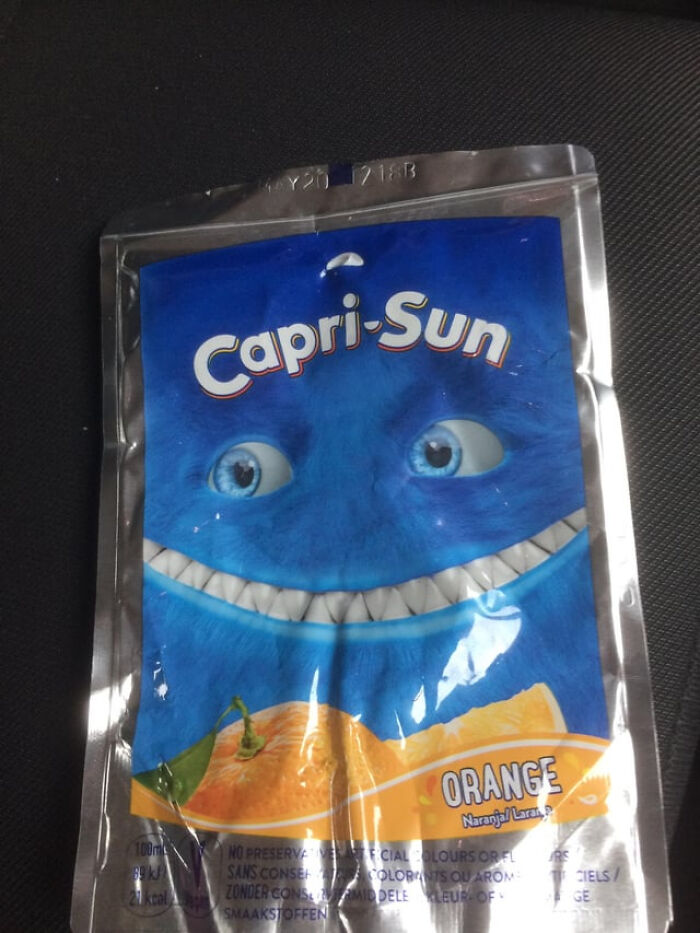 A Capri-Sun orange drink pouch with a blue cartoon face, a common everyday inconvenience.