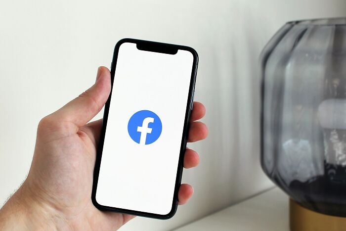 A phone displaying the Facebook logo, highlighting instances where clients made stupid errors through social media.