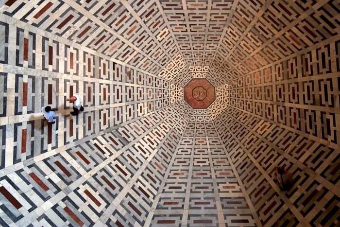 A high-angle view of two people on a patterned floor, creating a baffling image.