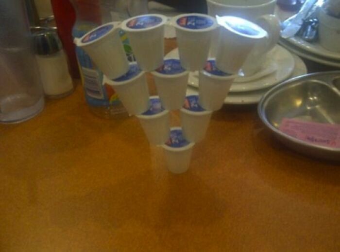 A pyramid of K-cups on a table, one of the baffling images that make no physical sense.